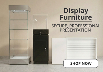Three modern glass and metal display cabinets shown against a beige studio background, with large text reading 'Display Furniture' and a 'SHOP NOW' button.
