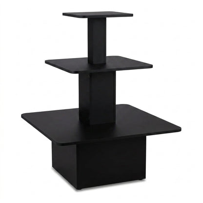 A modern three-tier black wooden display stand or riser with square platforms on a white background.