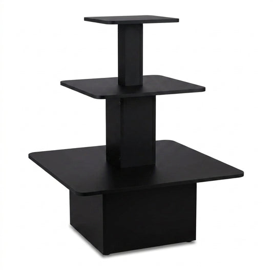 A modern three-tier black wooden display stand or riser with square platforms on a white background.