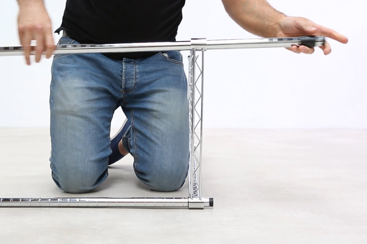 2. Insert Upright Posts into first Shelf