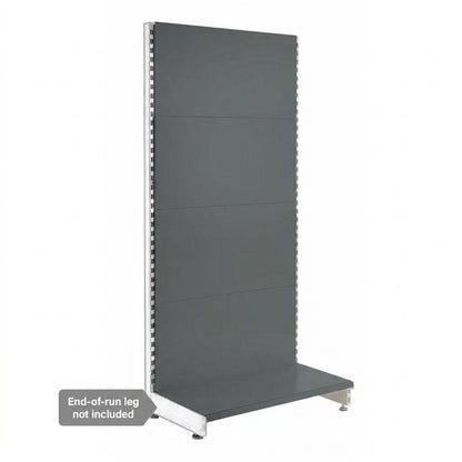 A dark gray retail display wall panel with a bottom shelf tray and silver metal support legs, shown on a white background with a note that the end-of-run leg is not included.