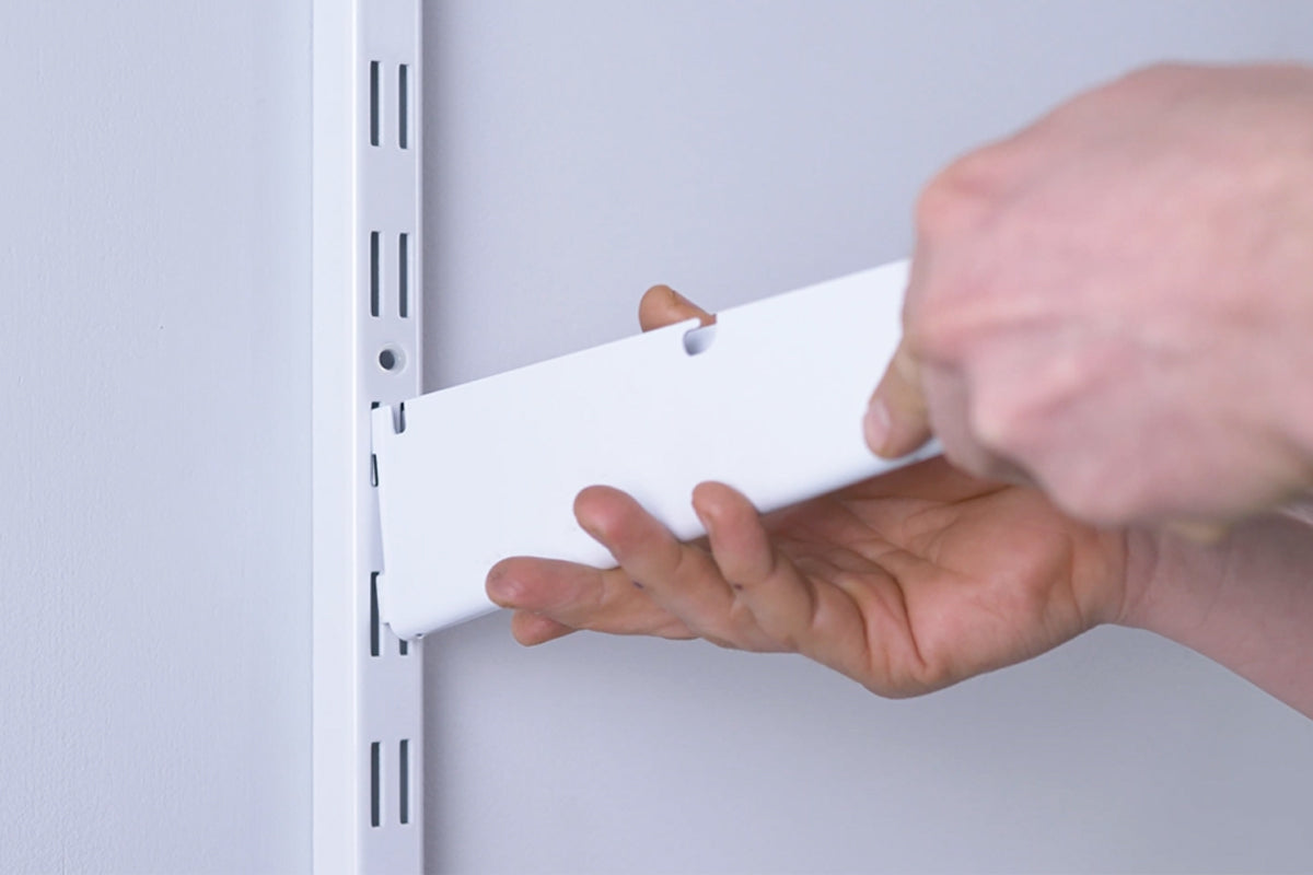 1. Drop Shelf Brackets onto Uprights