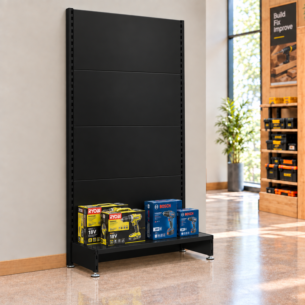 Black plain-panel wall unit against a hardware shop wall. Merchandise and end-of-run support not included.