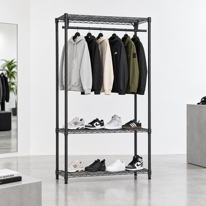 Carbon grey wire clothes rack with hoodies, jackets and trainers in a minimal modern streetwear store