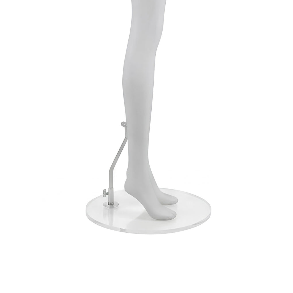 A white mannequin lower body on a round white display base with a small silver hanging accessory, photographed against a plain white background.