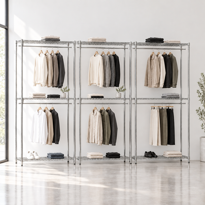 Three chrome racks in a minimal boutique
