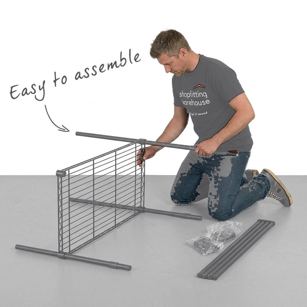 A man kneels on the floor assembling a gray metal wire grid fence panel. The image includes the text 'Easy to assemble' with an arrow pointing to the product.